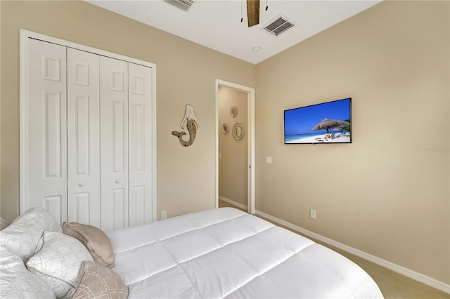 carpeted bedroom with ceiling fan and a closet