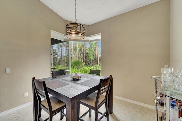 dining space with light tile patterned floors and a chandelier