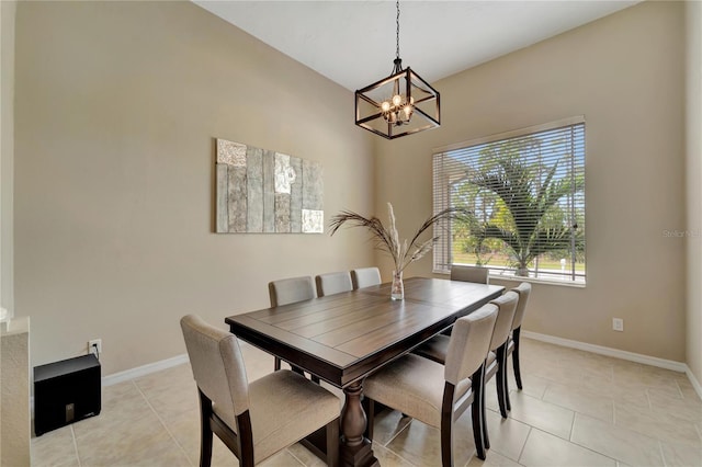 dining area featuring light tile patterned flooring and a notable chandelier