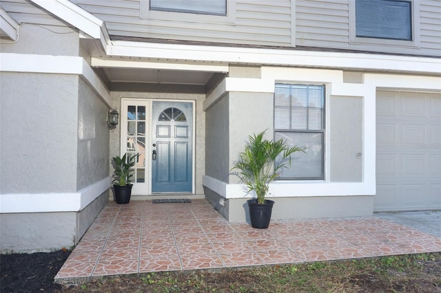 view of exterior entry featuring a garage