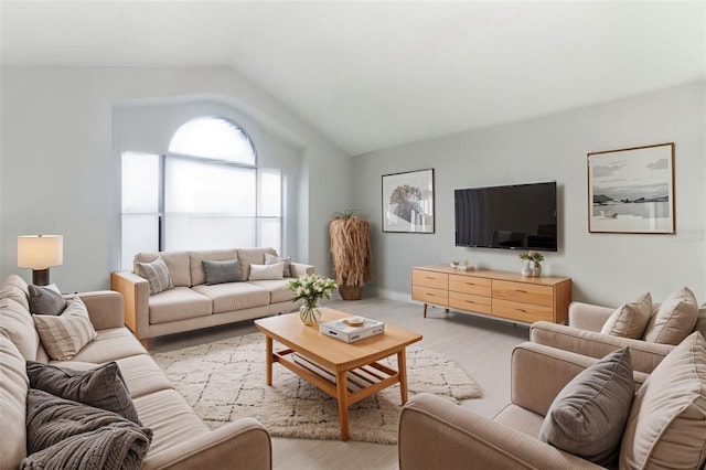 living room featuring vaulted ceiling and light hardwood / wood-style floors