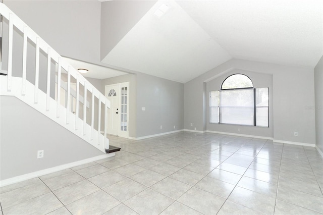 unfurnished living room featuring vaulted ceiling and light tile patterned floors