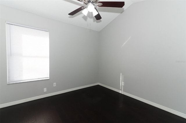 empty room featuring ceiling fan, hardwood / wood-style flooring, and lofted ceiling