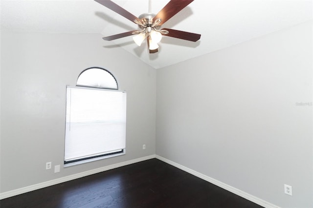 spare room featuring vaulted ceiling, ceiling fan, and dark hardwood / wood-style flooring