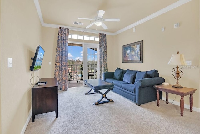 carpeted living room with ornamental molding and ceiling fan