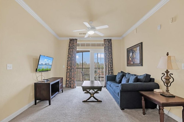 carpeted living room featuring ornamental molding and ceiling fan