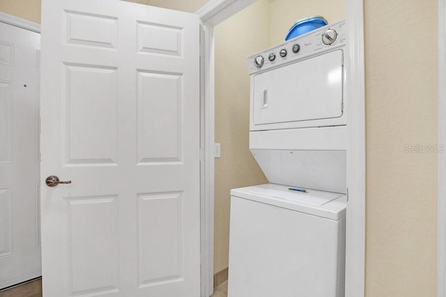 laundry area with stacked washer and dryer