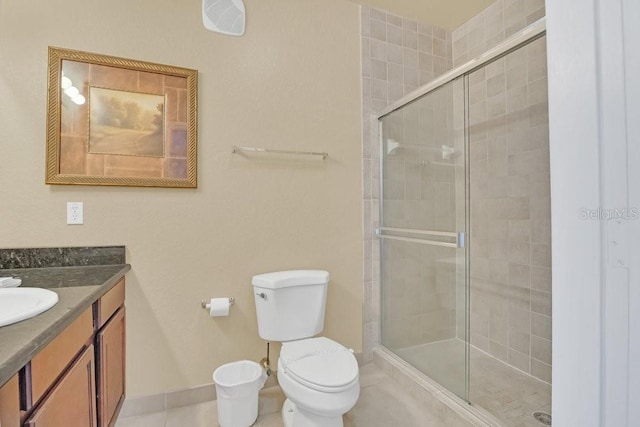 bathroom with walk in shower, vanity, toilet, and tile patterned flooring