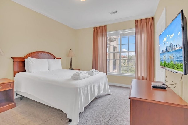 carpeted bedroom with multiple windows