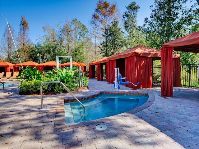 view of swimming pool with a patio and a gazebo