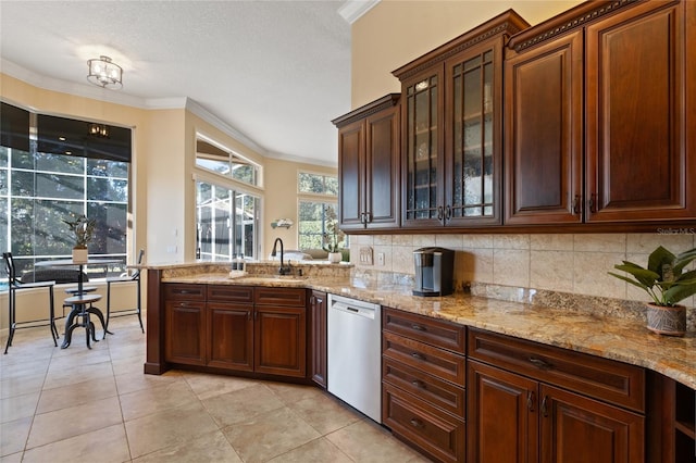 kitchen featuring crown molding, dishwasher, sink, and light tile patterned floors