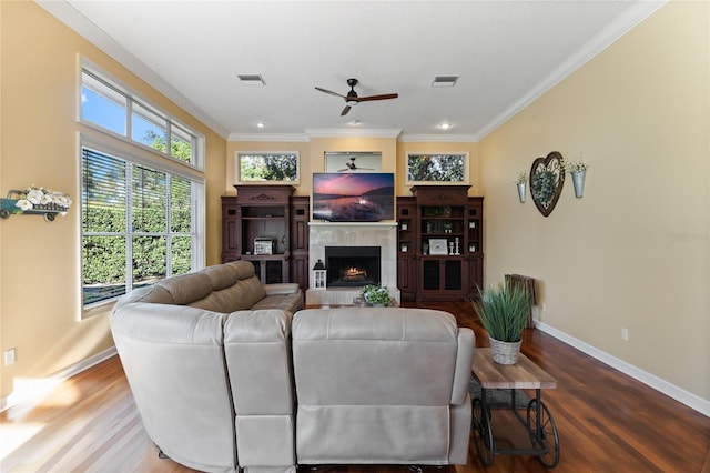 living room with hardwood / wood-style flooring, ornamental molding, and ceiling fan