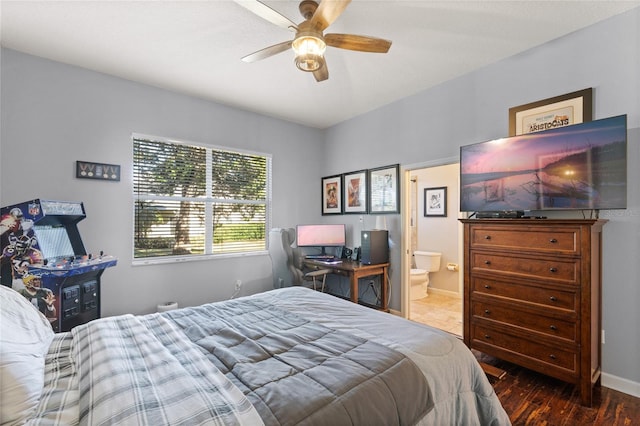 bedroom featuring connected bathroom, wood-type flooring, and ceiling fan