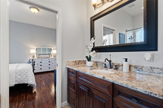 bathroom with hardwood / wood-style flooring and vanity