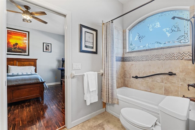 bathroom with shower / bath combination with curtain, ceiling fan, and toilet