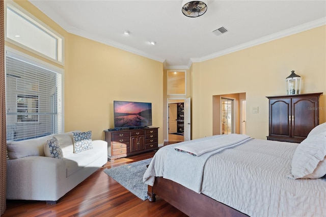 bedroom featuring crown molding and wood-type flooring