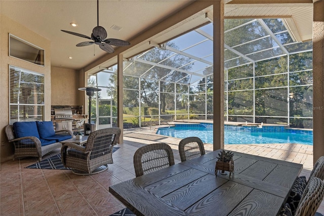 view of patio featuring ceiling fan, an outdoor living space, grilling area, and glass enclosure