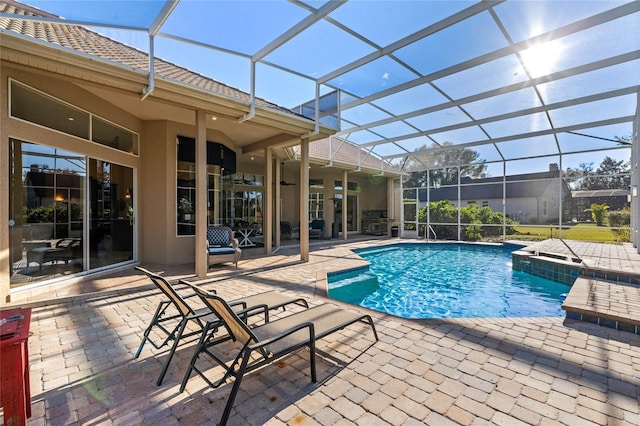 view of pool featuring ceiling fan, a lanai, and a patio area