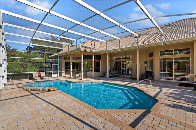 view of pool featuring a patio area and glass enclosure