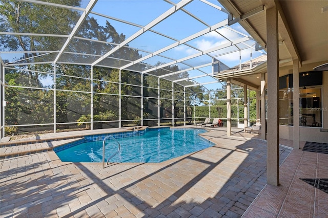 view of pool with a patio and glass enclosure