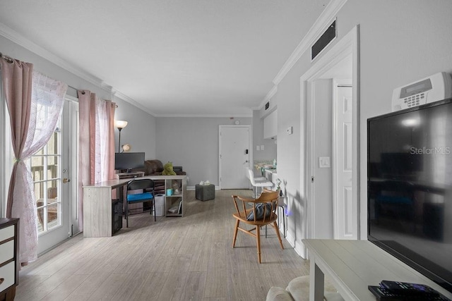 living room featuring light wood-type flooring and ornamental molding