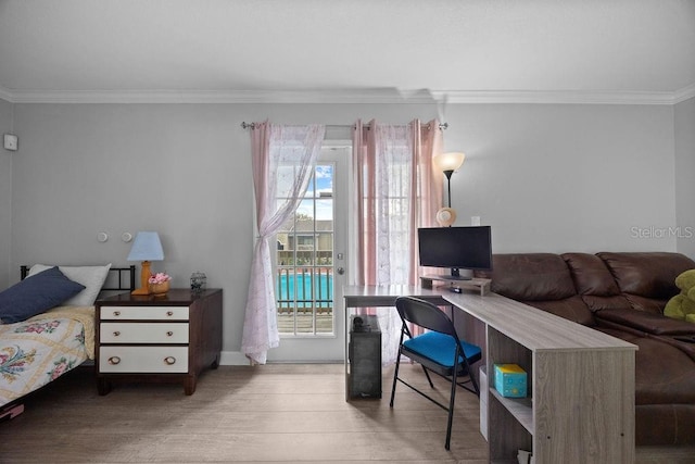 bedroom featuring access to exterior, hardwood / wood-style floors, and ornamental molding