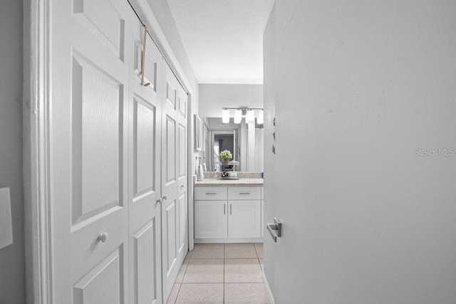 corridor with light tile patterned floors