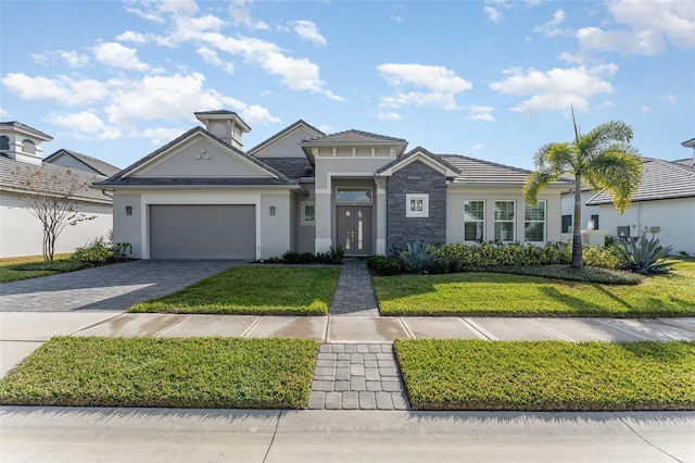 view of front of property with a garage and a front lawn