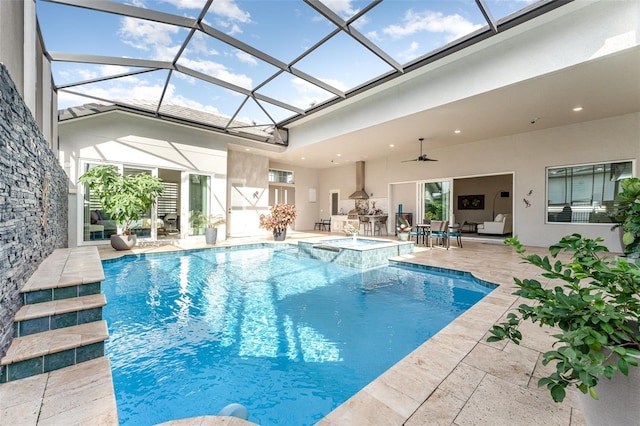 view of pool with an in ground hot tub, glass enclosure, ceiling fan, and a patio area