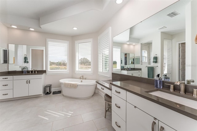 bathroom with vanity, tile patterned floors, and a bathtub