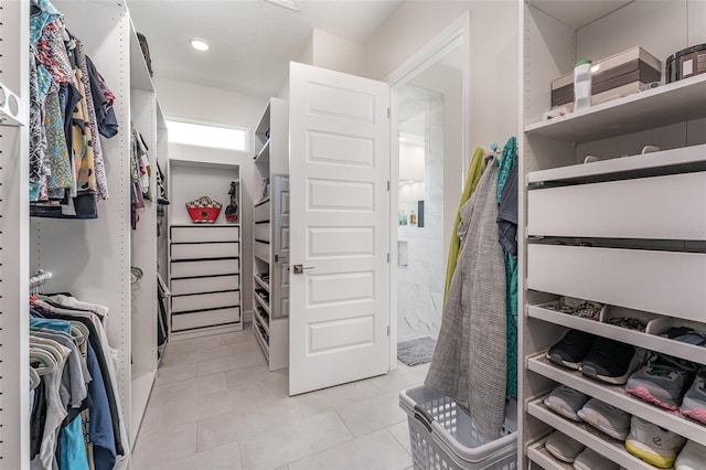 walk in closet featuring light tile patterned floors