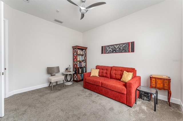 carpeted living room with ceiling fan