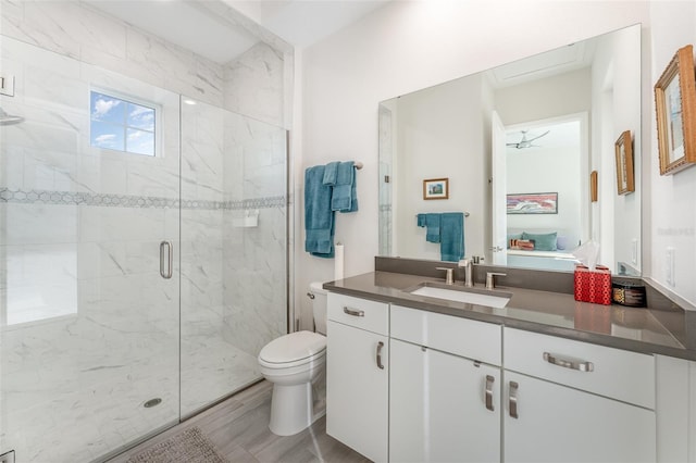 bathroom with toilet, walk in shower, ceiling fan, and vanity