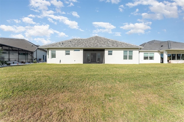 rear view of house featuring a yard