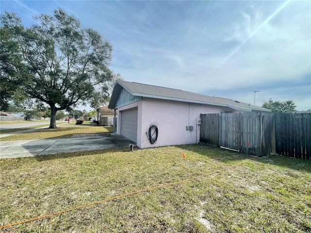 view of property exterior featuring a garage and a yard