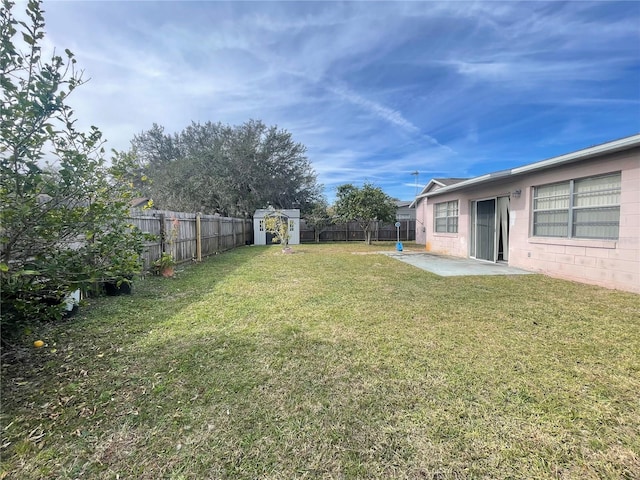 view of yard featuring a shed and a patio