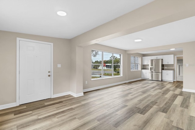 unfurnished living room featuring light wood-type flooring