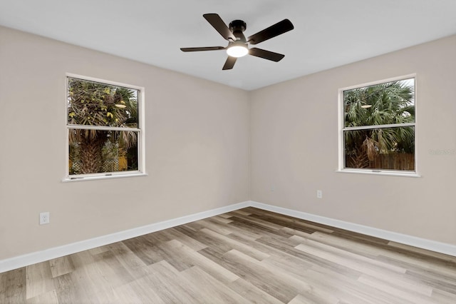 empty room featuring ceiling fan and light hardwood / wood-style floors