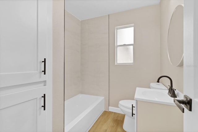 full bathroom with toilet,  shower combination, hardwood / wood-style flooring, and vanity