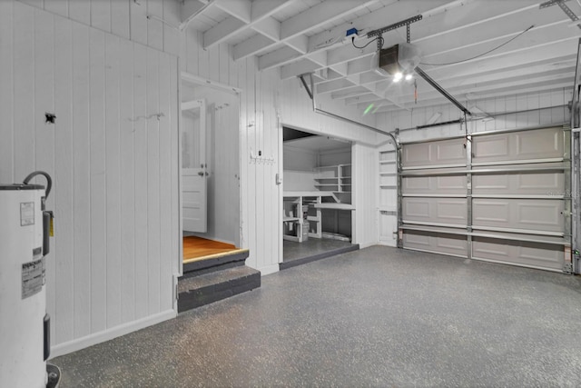 garage with electric water heater, a garage door opener, and wooden walls