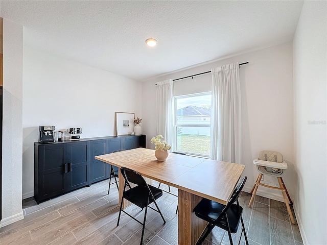 dining area with a textured ceiling