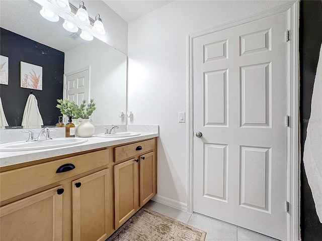 bathroom with tile patterned floors and vanity