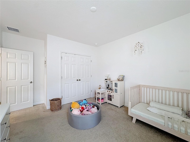 bedroom featuring light carpet and a closet