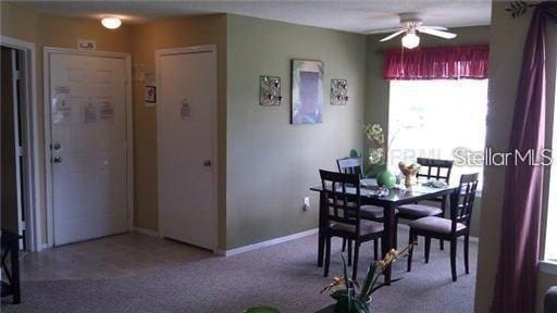 dining room featuring ceiling fan and carpet flooring