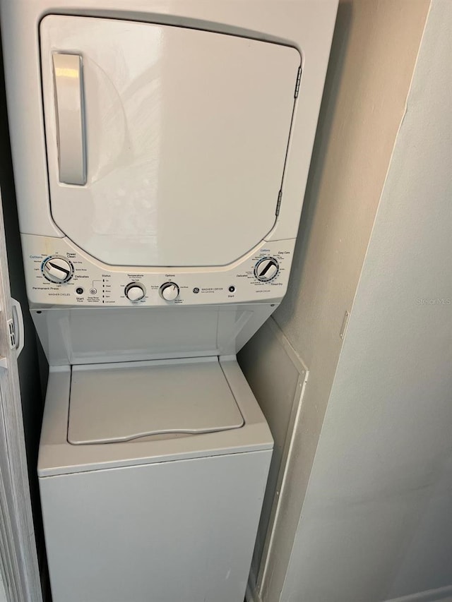 laundry area with stacked washer and dryer