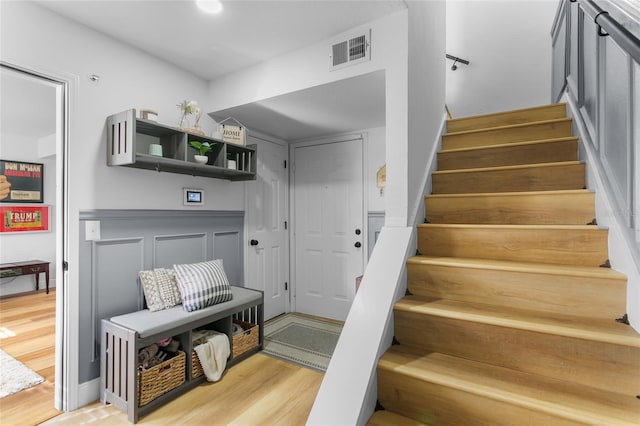 staircase with hardwood / wood-style flooring