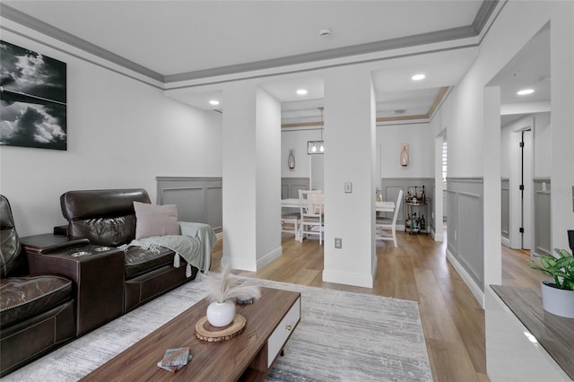 living room featuring light hardwood / wood-style flooring and ornamental molding