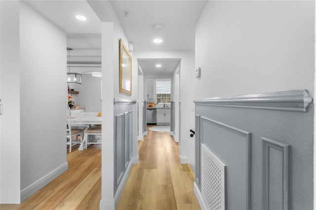 hall featuring sink and light hardwood / wood-style flooring