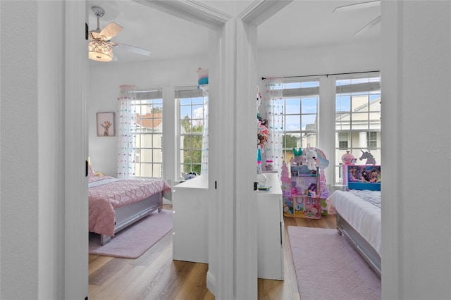 bedroom with light wood-type flooring and ceiling fan