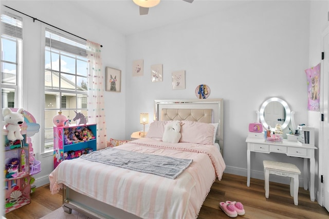 bedroom featuring wood-type flooring, multiple windows, and ceiling fan